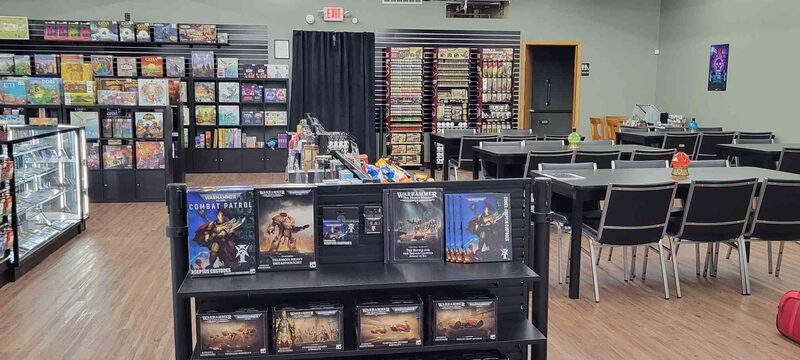 The shop floor, board games along the wall and event tables at the back